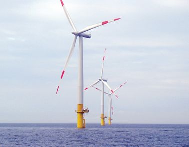 Three windmills at sea