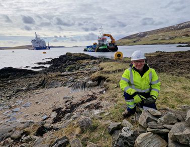 shetland employee at the shore